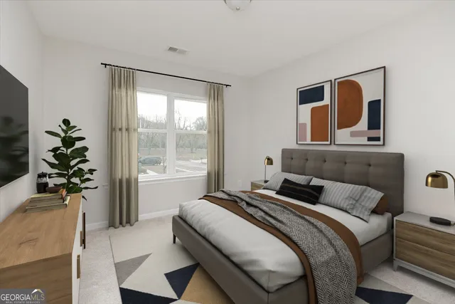 a bedroom with a bed and a flat tv screen on the dresser