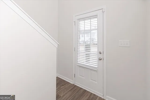 a view of an empty room and wooden floor