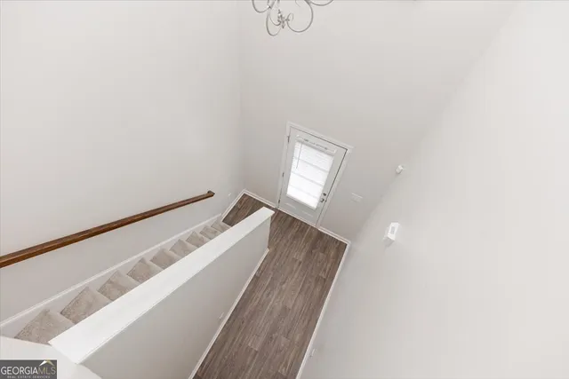 a view of a room with wooden floor and a ceiling fan