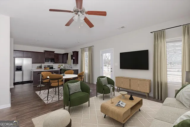 a living room with furniture and a flat screen tv