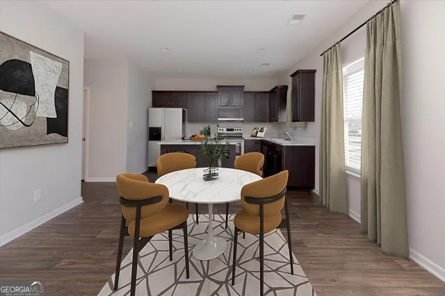 a view of a dining room with furniture and wooden floor