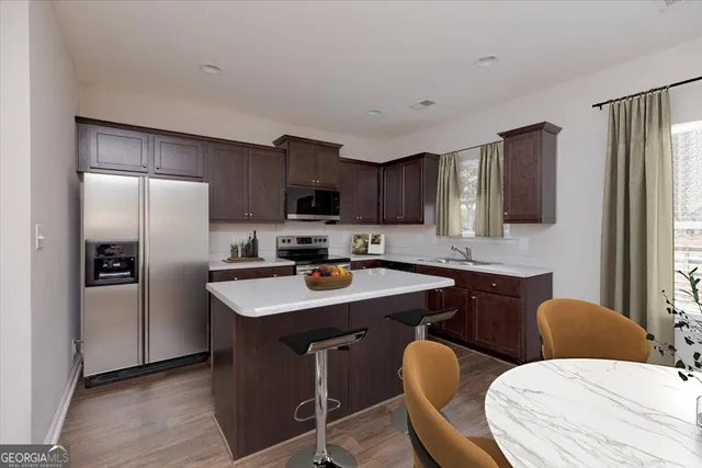 a kitchen with stainless steel appliances granite countertop a sink stove and cabinets