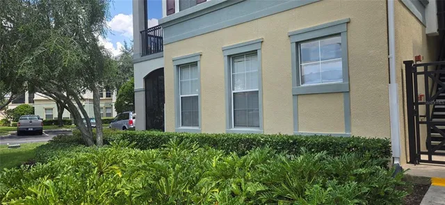 a view of a house with a yard and tree s