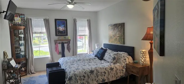 a bed sitting in a bedroom next to a window