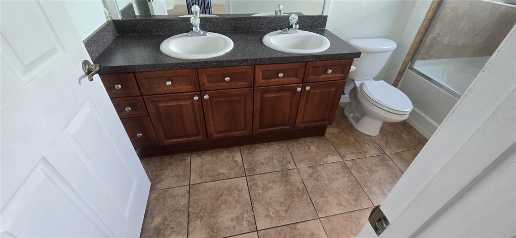 8180 Boat Hook Loop, Unit 108/301 Windermere, FL 34786 - Photo 15 of 27 a bathroom with a sink a toilet and a mirror