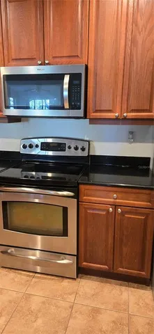 a stove top oven sitting inside of a kitchen