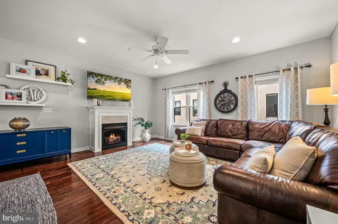 a living room with furniture and wooden floor