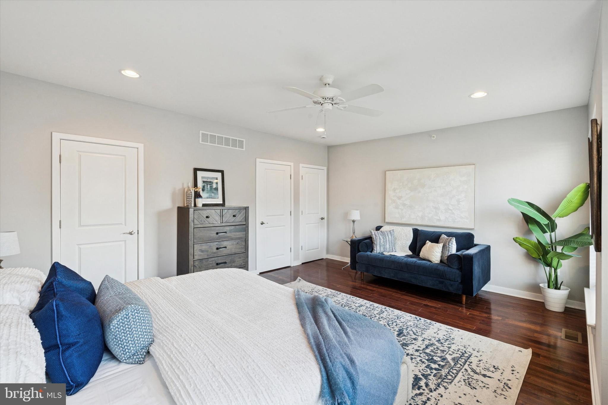 1305 South 2nd Street Philadelphia, PA 19147 - Photo 14 of 30 a spacious bedroom with a bed a couch and wooden floor