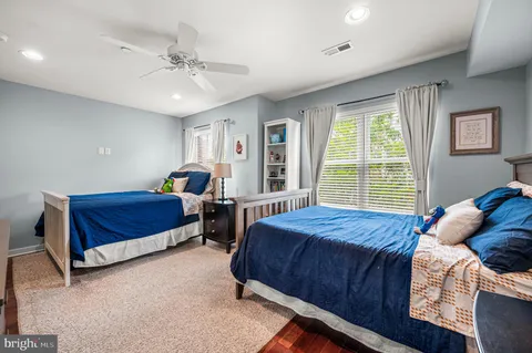 a view of a bedroom with furniture and window