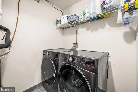 a bathroom with a granite countertop sink mirror and a bath tub