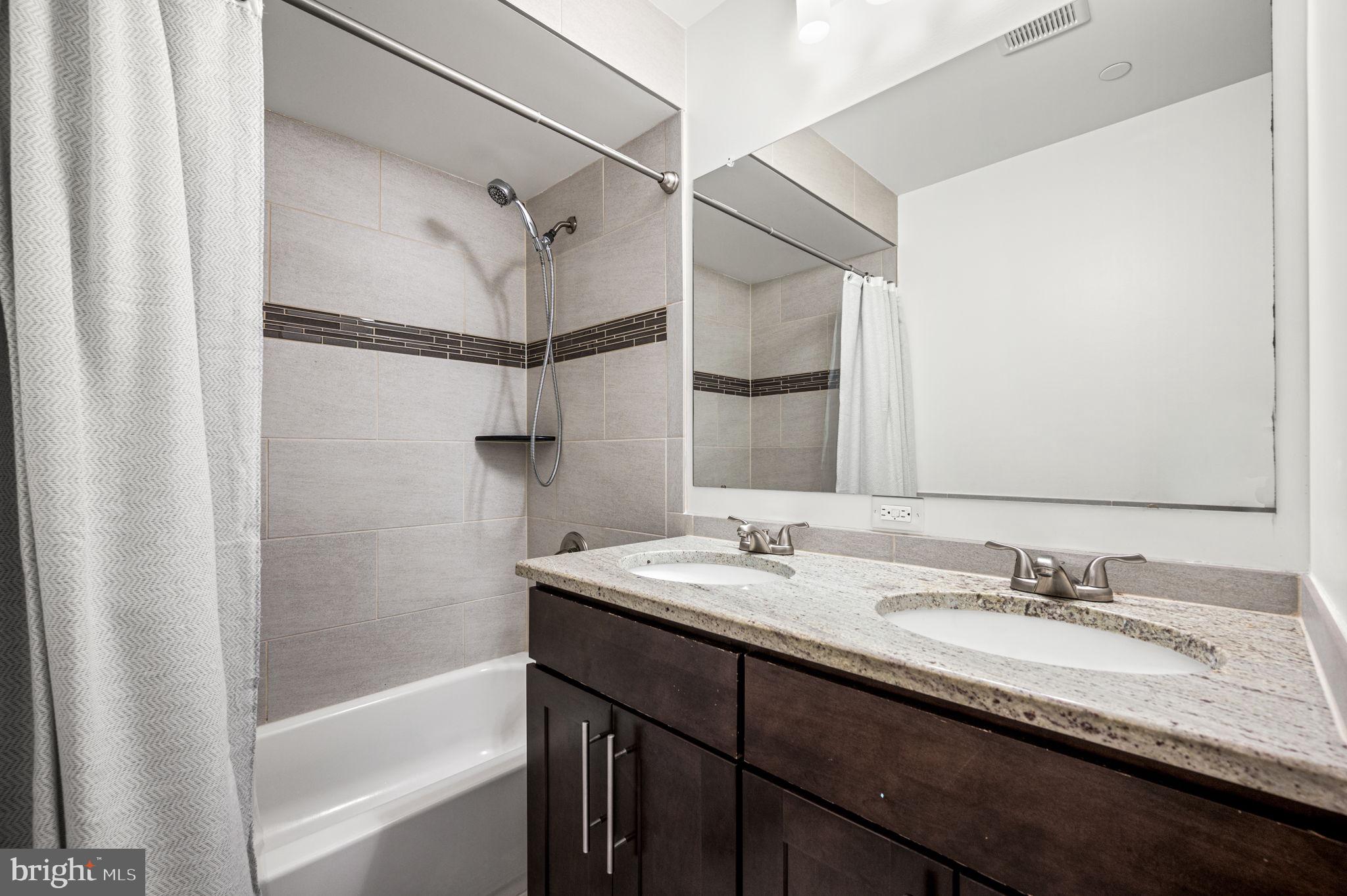 1305 South 2nd Street Philadelphia, PA 19147 - Photo 19 of 30 a bathroom with a granite countertop sink mirror and a bath tub