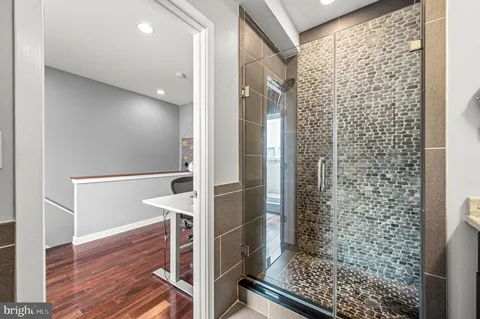 a bathroom with a granite countertop sink a toilet and a mirror