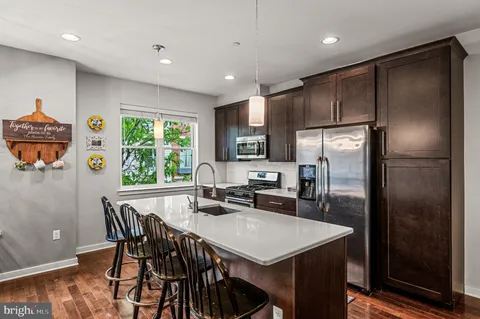 a large kitchen with a table and chairs