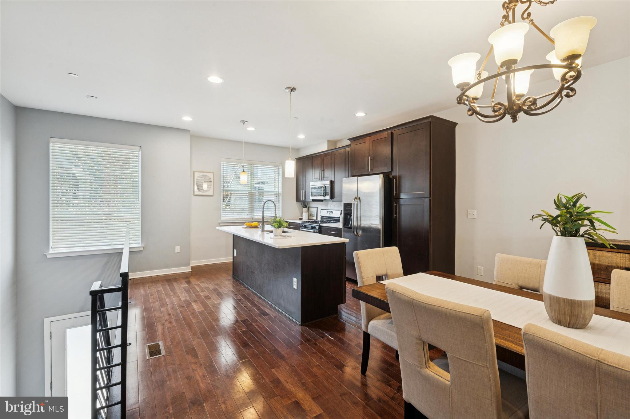 1305 South 2nd Street Philadelphia, PA 19147 - Photo 6 of 30 a kitchen with a refrigerator a sink dishwasher a dining table and chairs with wooden floor