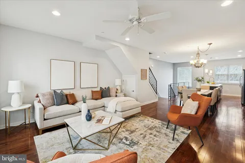 a living room with furniture and a wooden floor