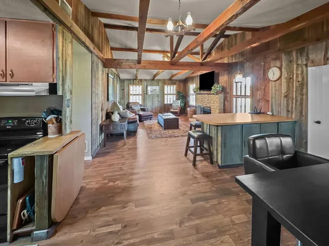 a bedroom with a large bed chandelier and a window