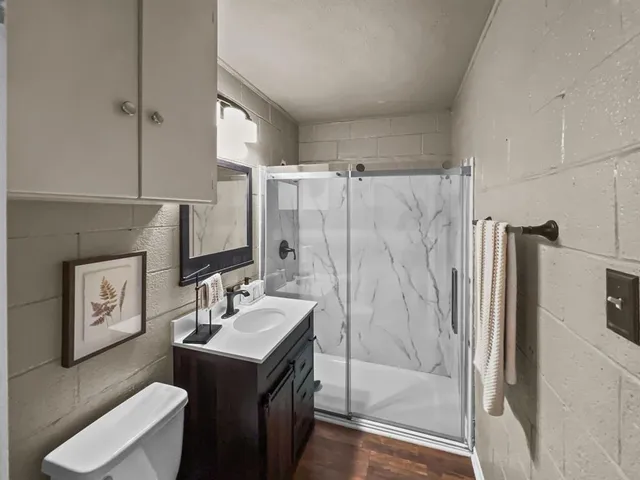 a bedroom with a large bed and a window