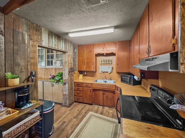 a kitchen with lots of counter top space and wooden floor