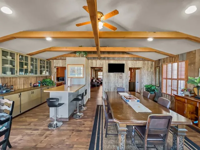 a dining room with furniture and wooden floor