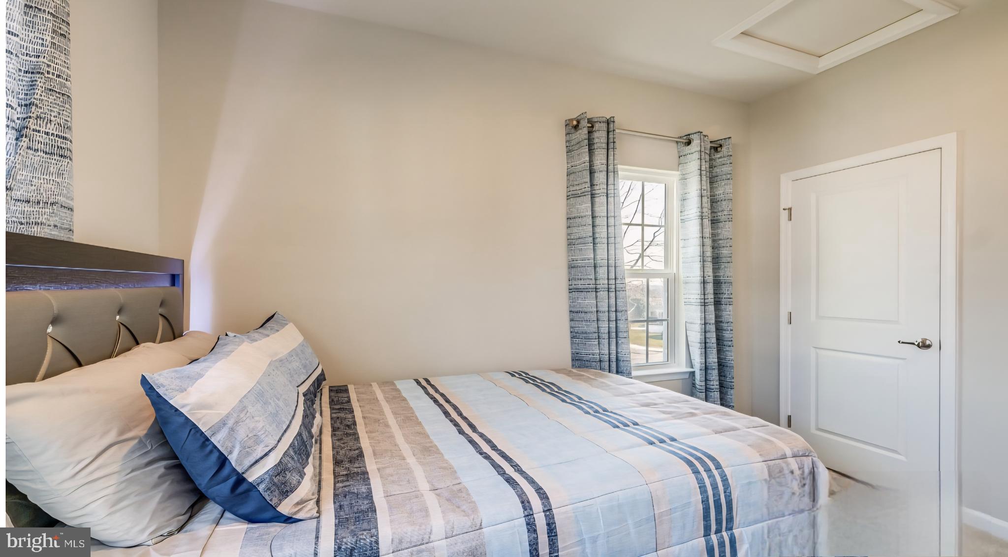 14489 Dolce Lane Woodbridge, VA 22193 - Photo 11 of 26 a bedroom with a bed and a window