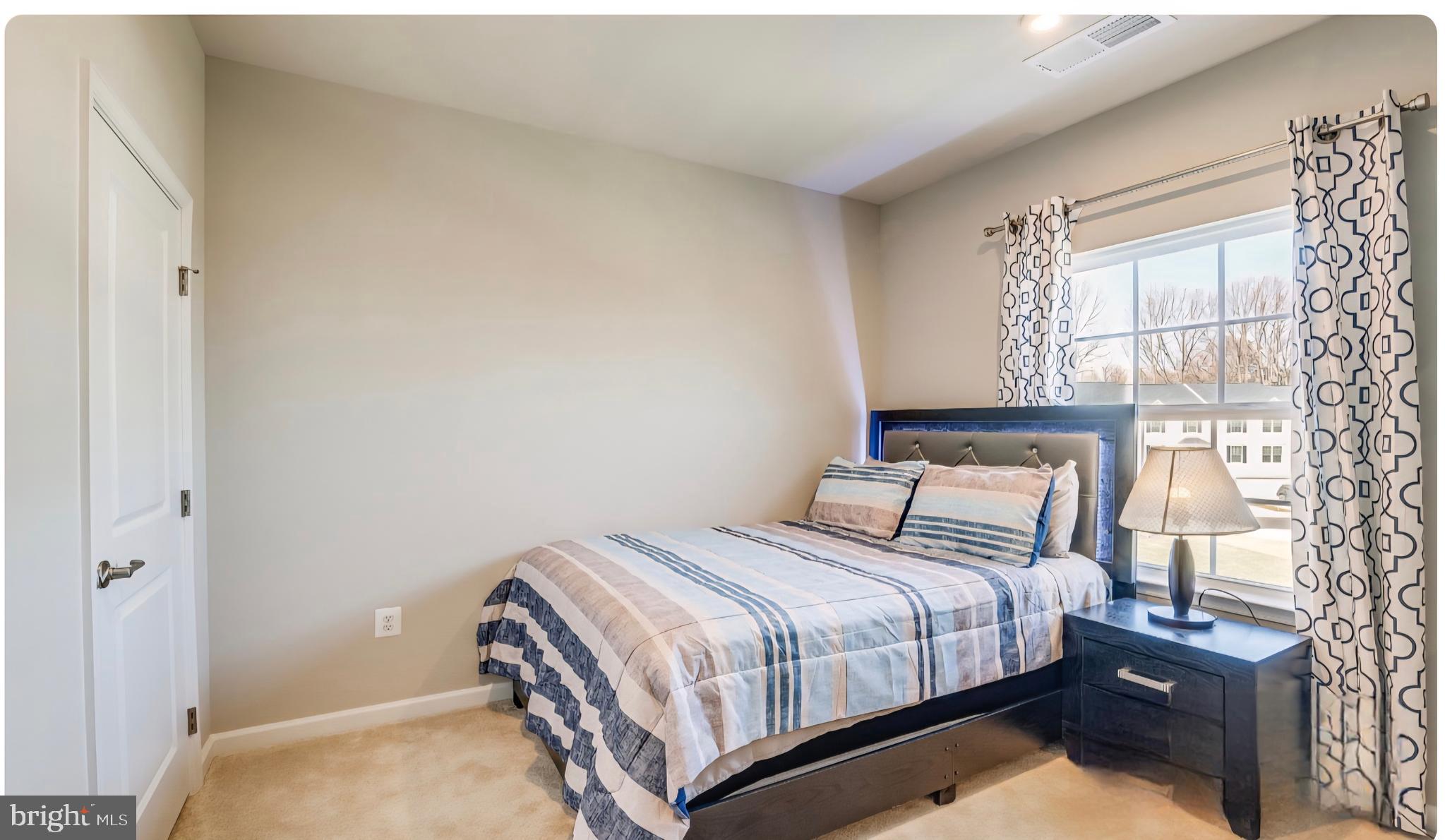 14489 Dolce Lane Woodbridge, VA 22193 - Photo 15 of 26 a bedroom with a bed and a window