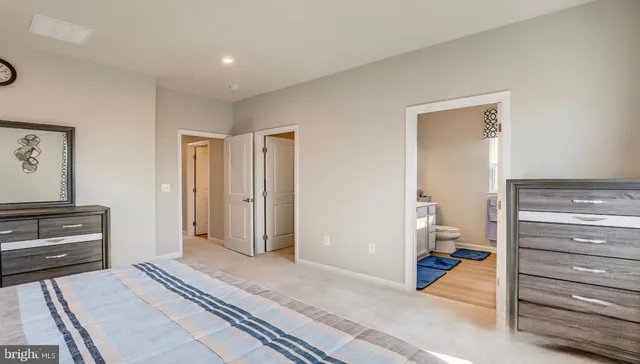 a view of a bedroom with closet and cabinet