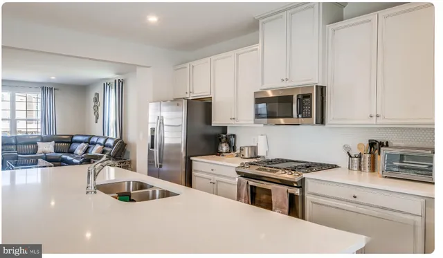 a kitchen with a sink stove and refrigerator