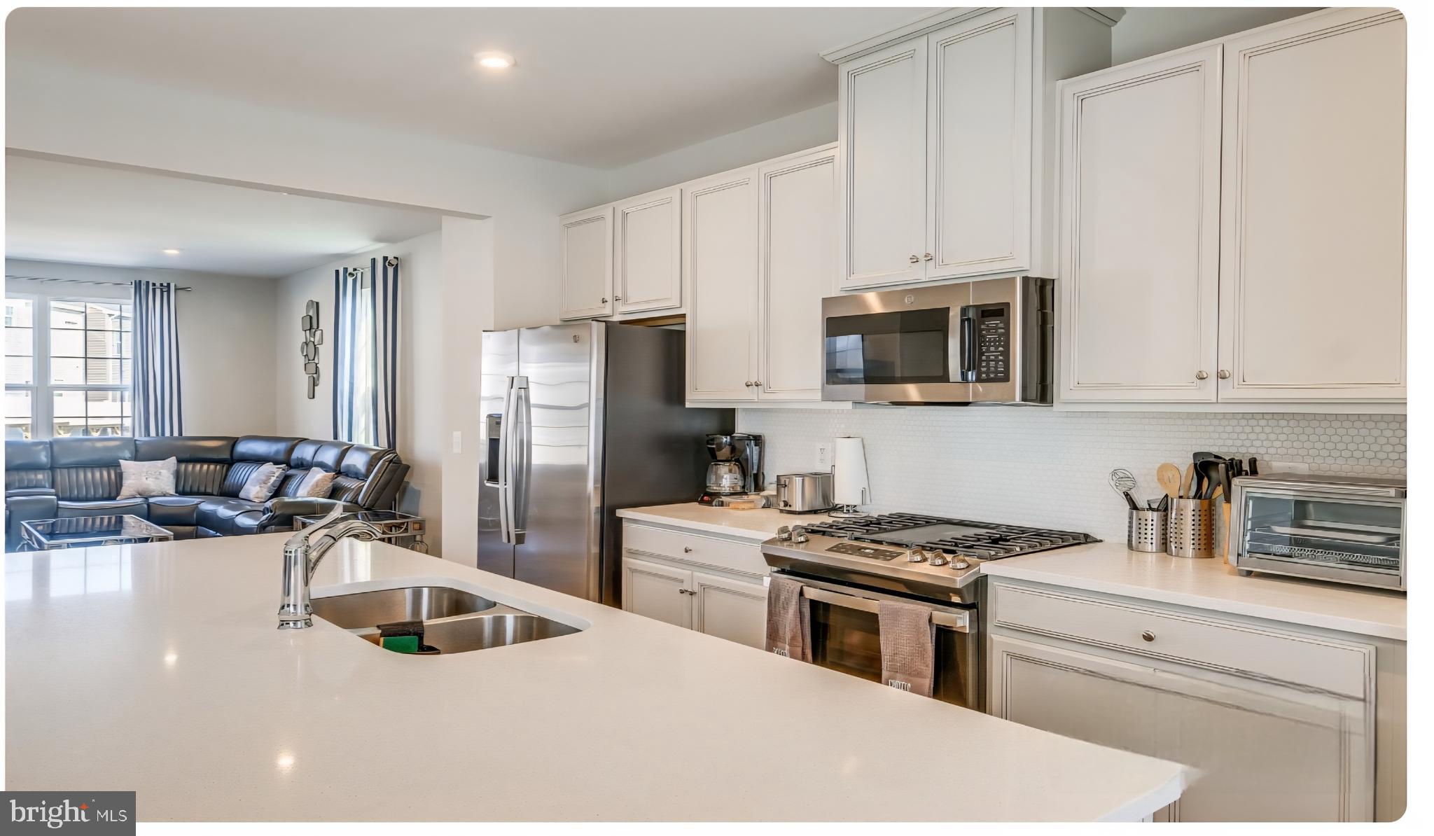 14489 Dolce Lane Woodbridge, VA 22193 - Photo 2 of 26 a kitchen with a sink stove and refrigerator