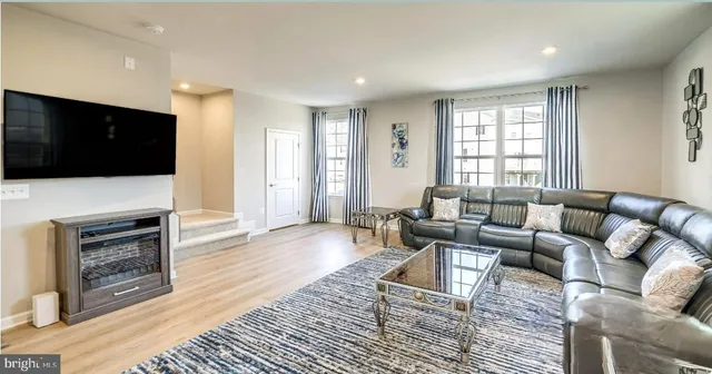 a living room with fireplace furniture and a flat screen tv