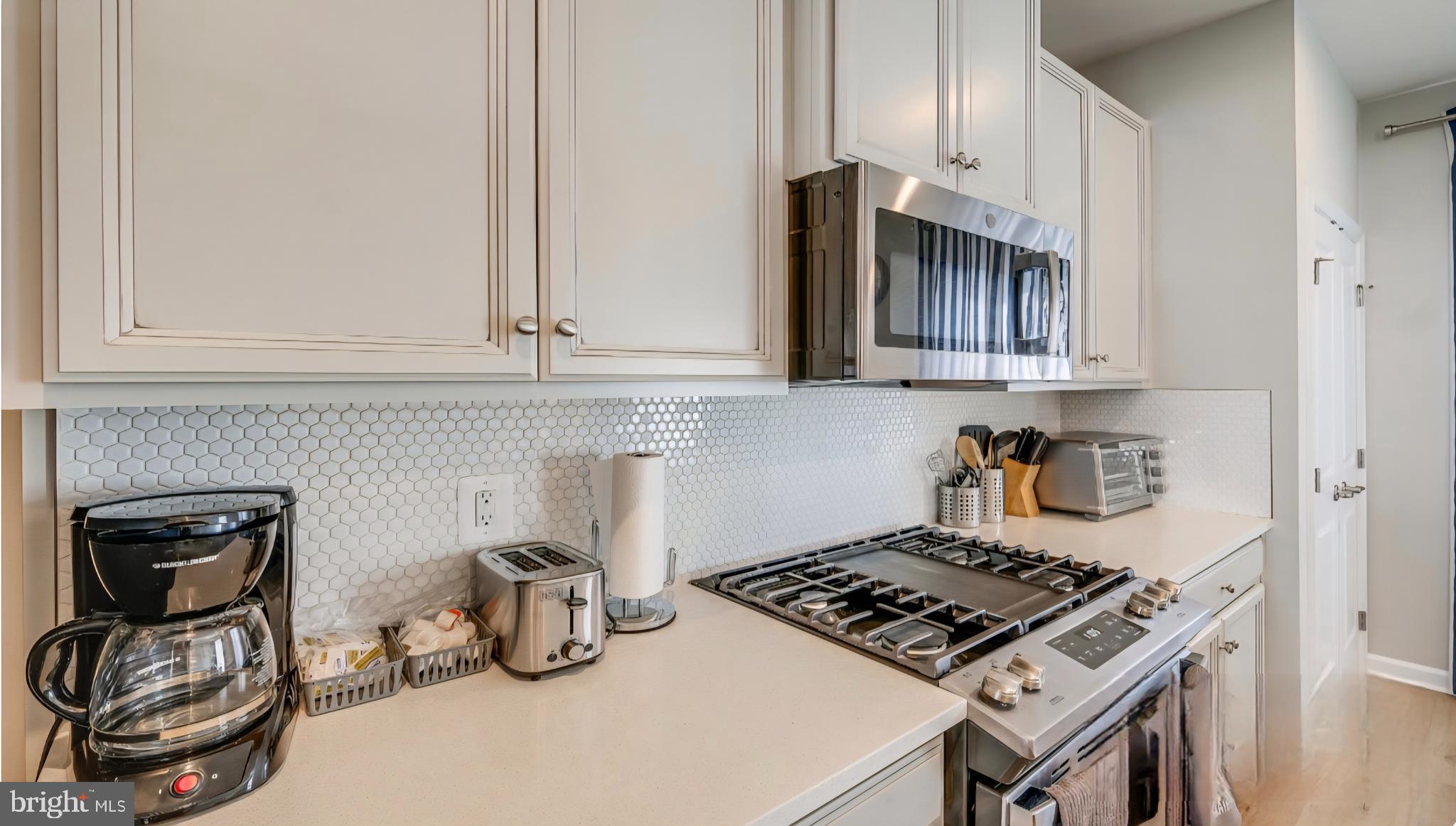 14489 Dolce Lane Woodbridge, VA 22193 - Photo 5 of 26 a kitchen with a stove and cabinets