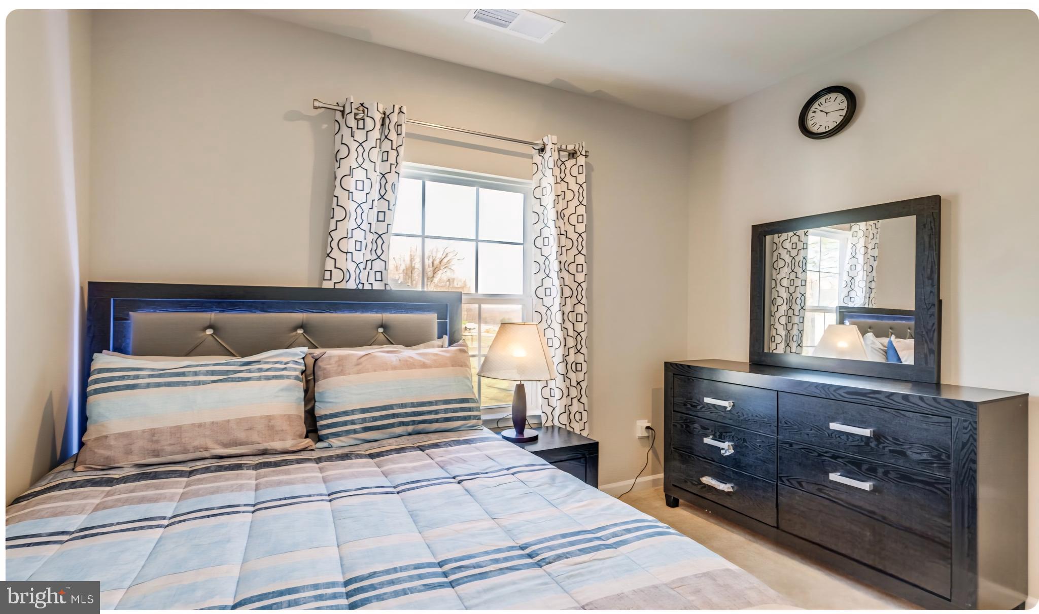 14489 Dolce Lane Woodbridge, VA 22193 - Photo 9 of 26 a spacious bedroom with a bed and a dresser