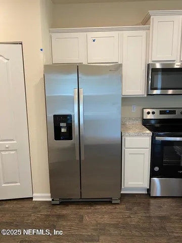 a kitchen with a refrigerator and a stove