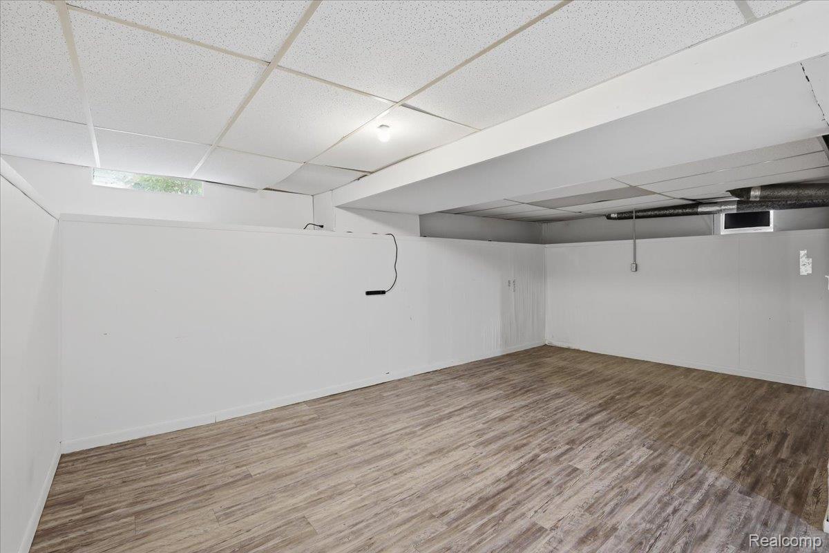 5307 Drayton Road Clarkston, MI 48346 - Photo 25 of 46 Finished basement space featuring wood-look flooring and white walls