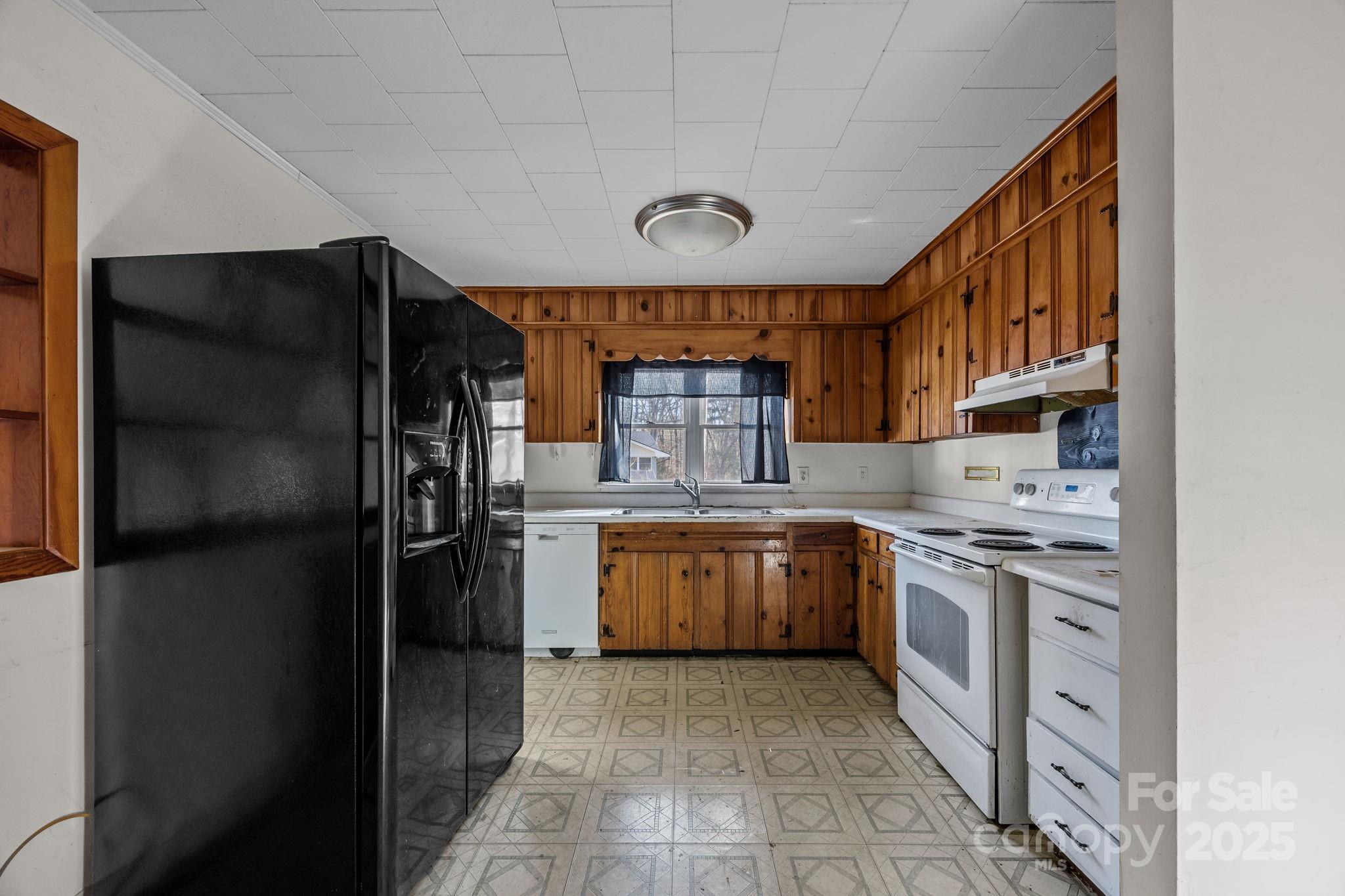 228 Grove Street Brevard, NC 28712 - Photo 14 of 44 a kitchen with stainless steel appliances granite countertop a refrigerator and a stove top oven