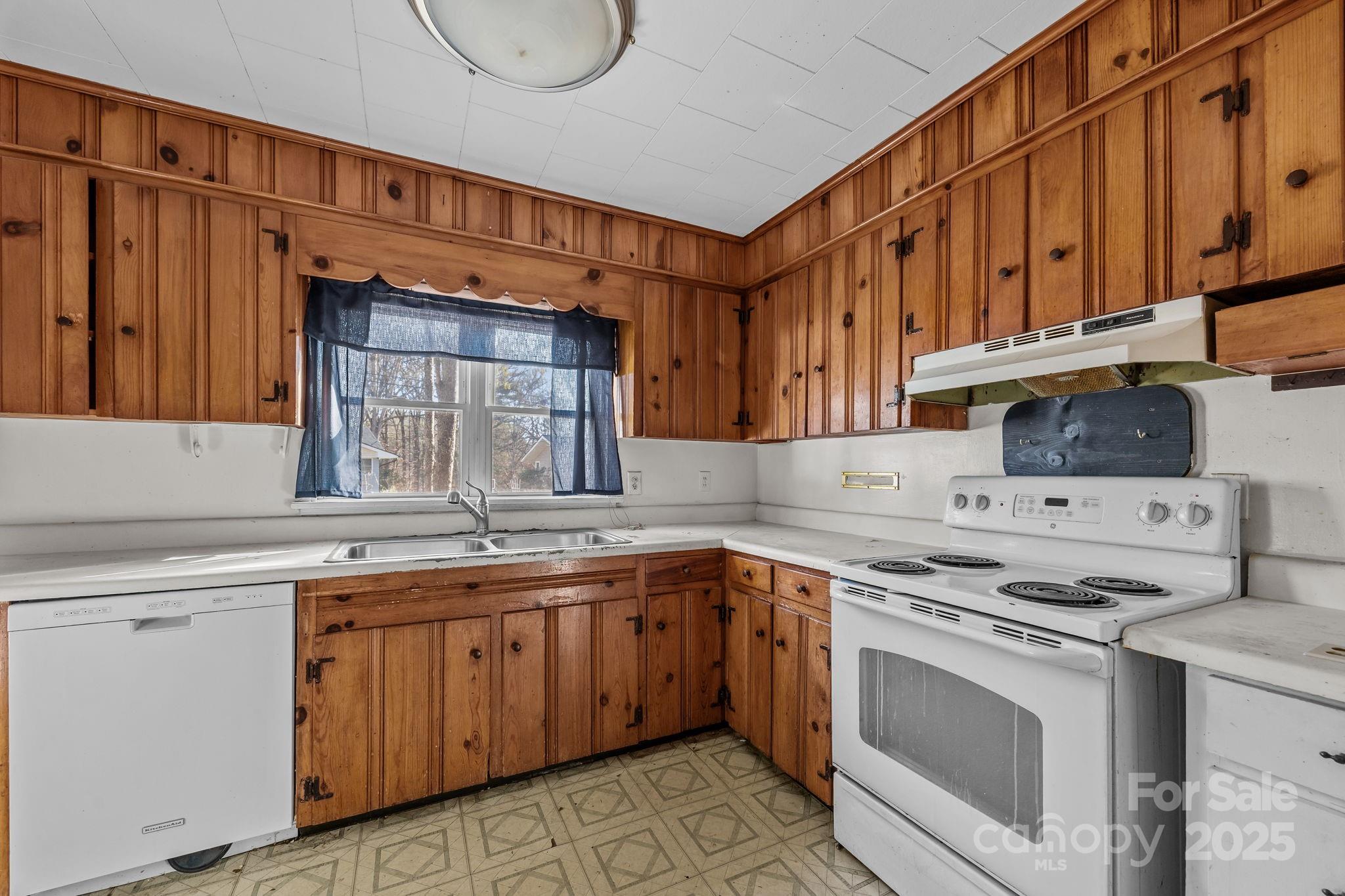 228 Grove Street Brevard, NC 28712 - Photo 16 of 44 a kitchen with a sink stove and cabinets