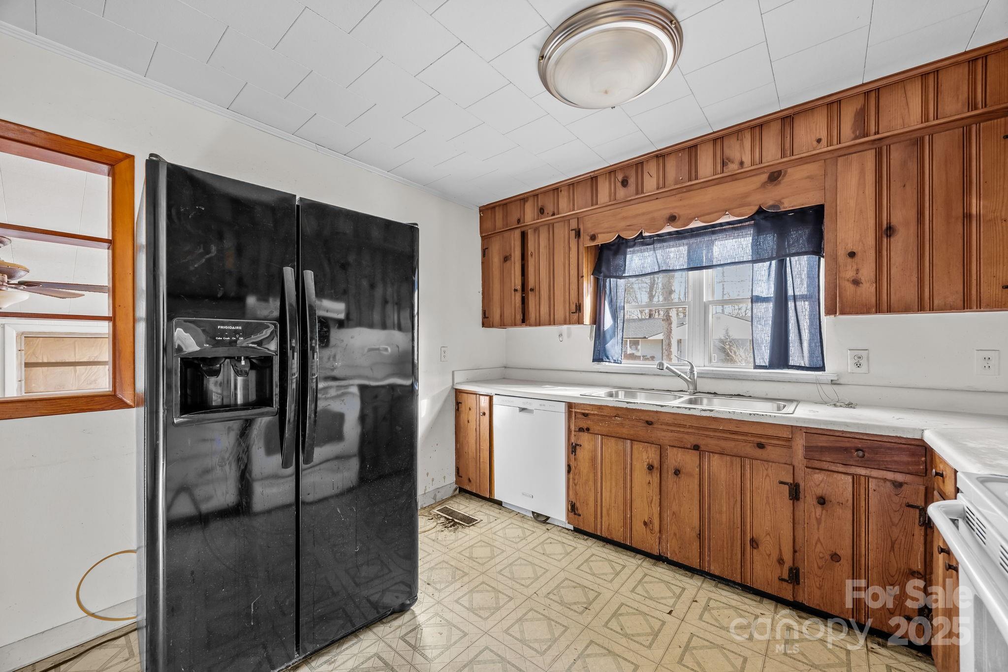 228 Grove Street Brevard, NC 28712 - Photo 17 of 44 a kitchen with stainless steel appliances granite countertop a sink and cabinets