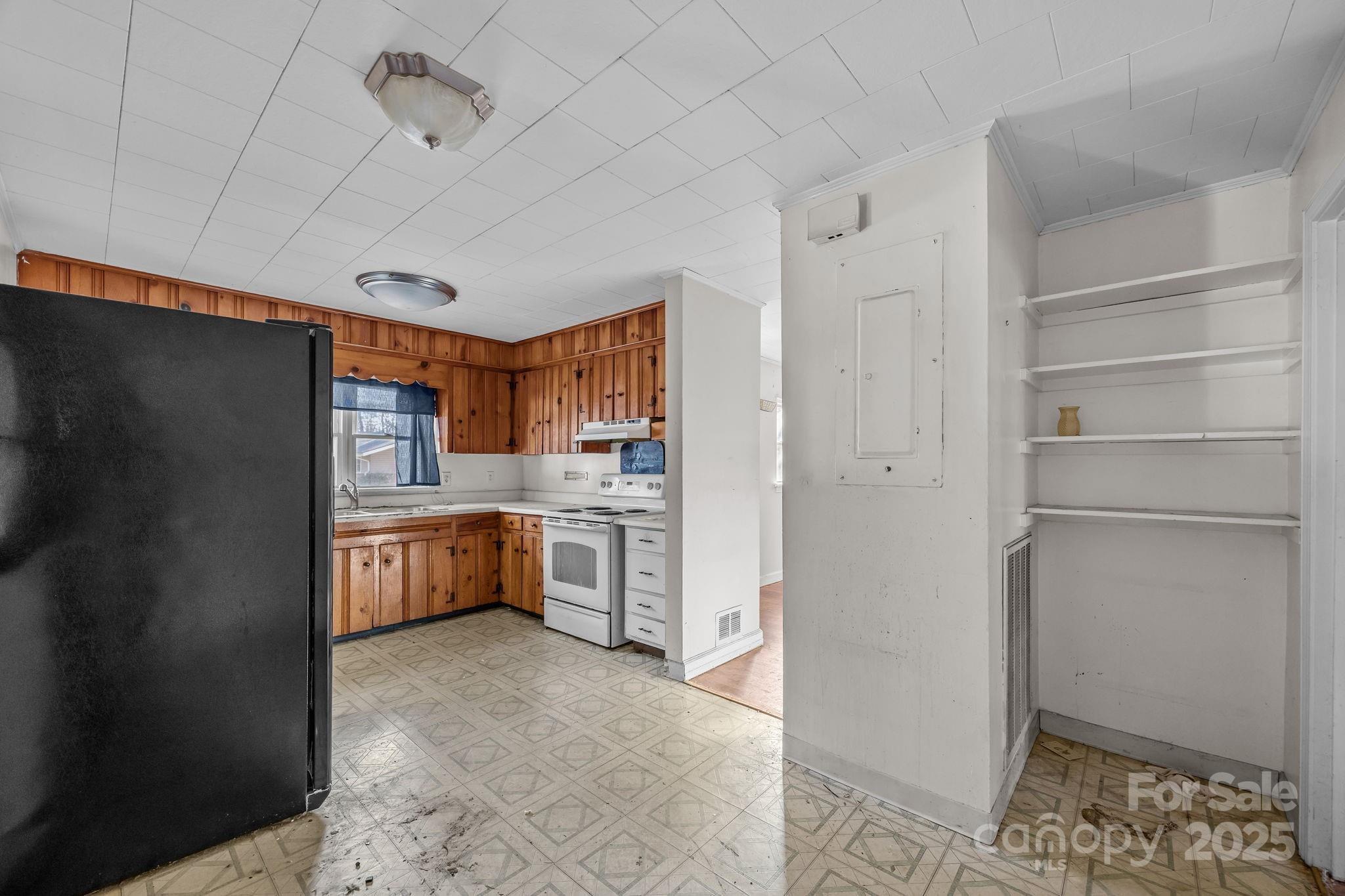 228 Grove Street Brevard, NC 28712 - Photo 20 of 44 a kitchen with white cabinets and refrigerator