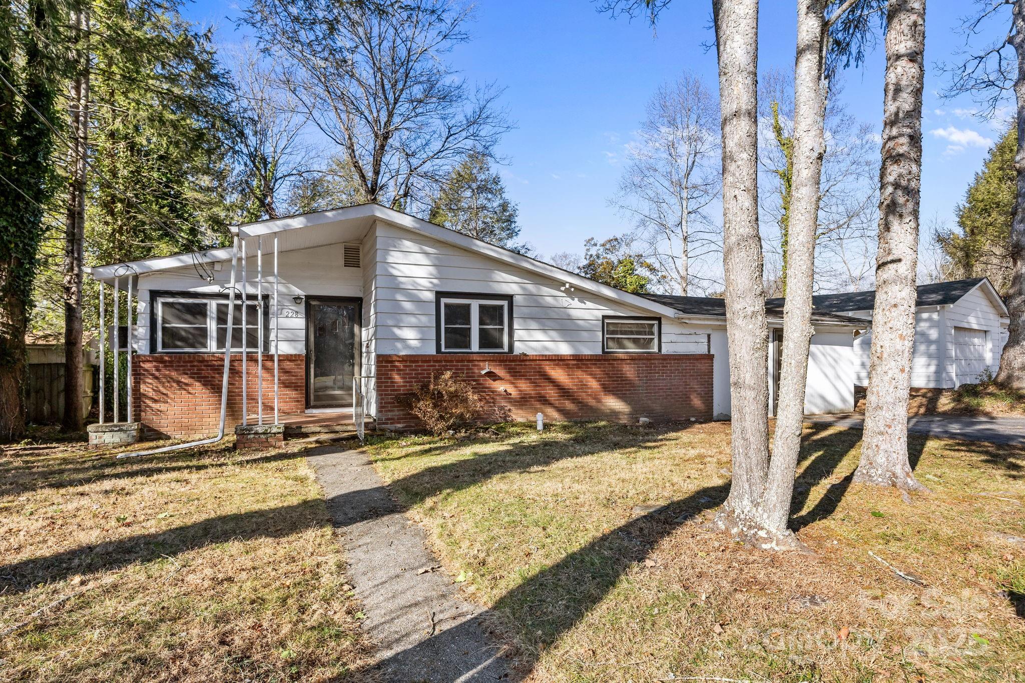 228 Grove Street Brevard, NC 28712 - Photo 2 of 44 a view of a house with snow on the road