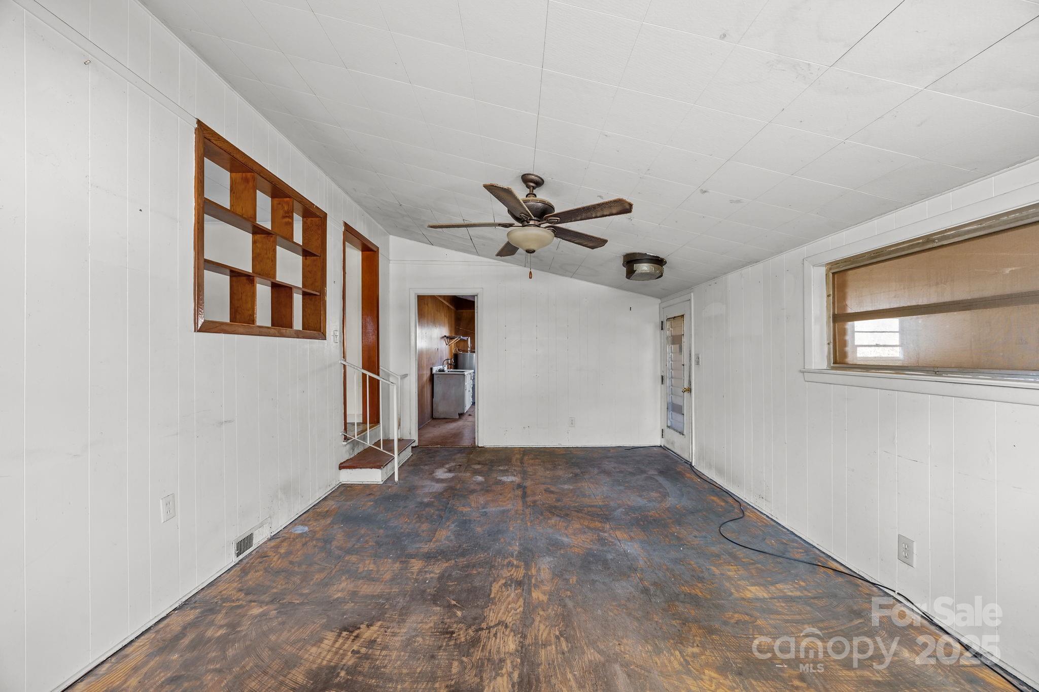 228 Grove Street Brevard, NC 28712 - Photo 23 of 44 a view of a livingroom with a ceiling fan & windows