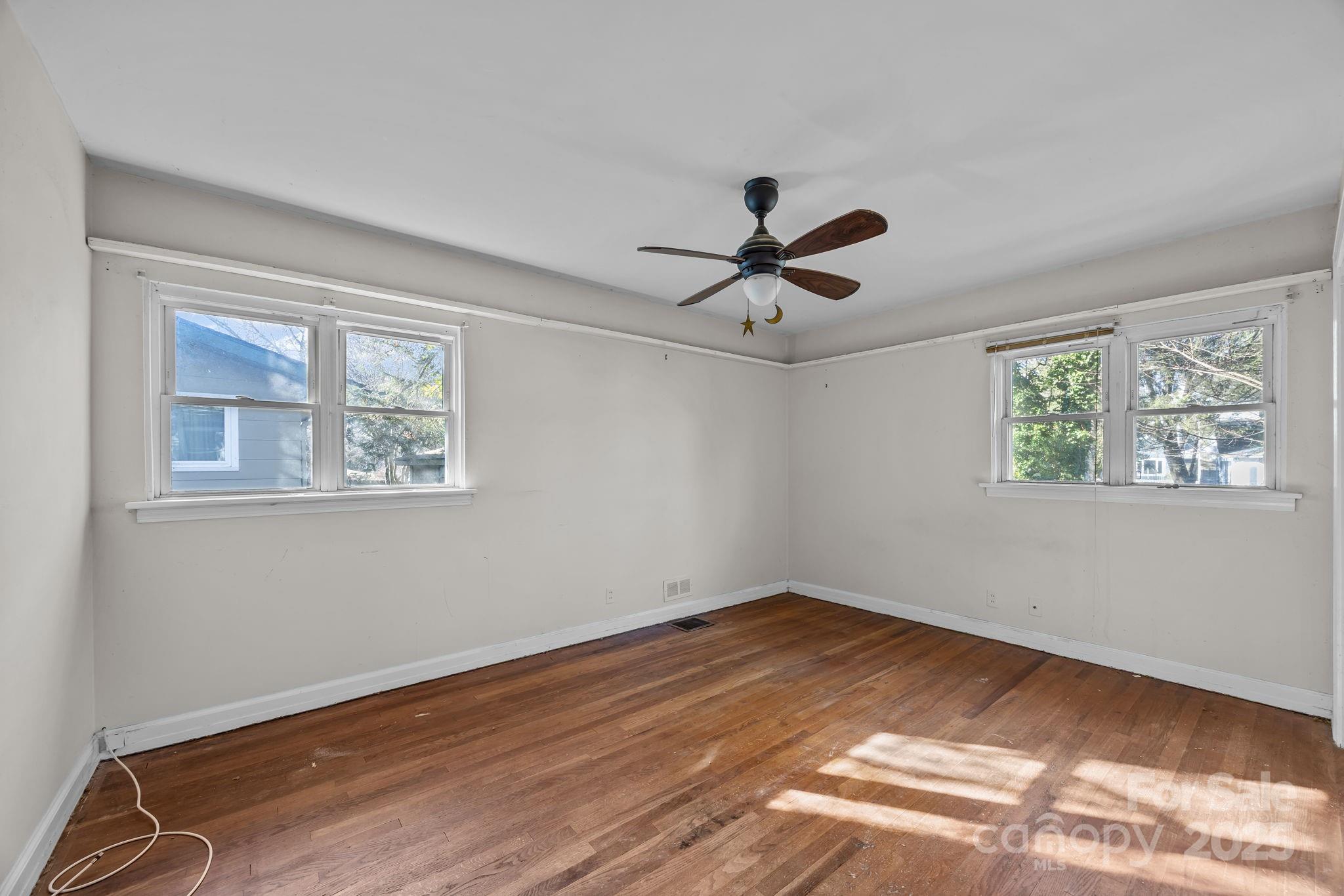 228 Grove Street Brevard, NC 28712 - Photo 26 of 44 a view of empty room with wooden floor and fan