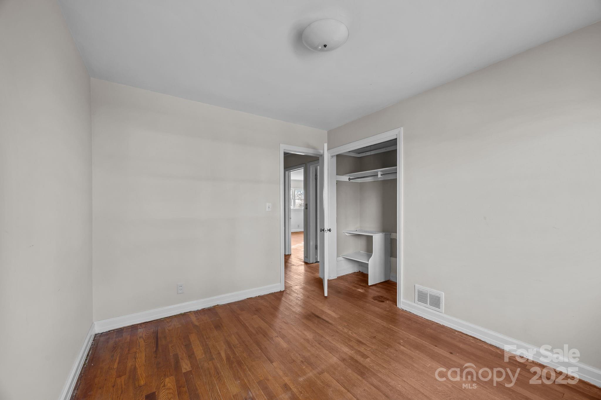 228 Grove Street Brevard, NC 28712 - Photo 29 of 44 a view of empty room with wooden floor and cabinet