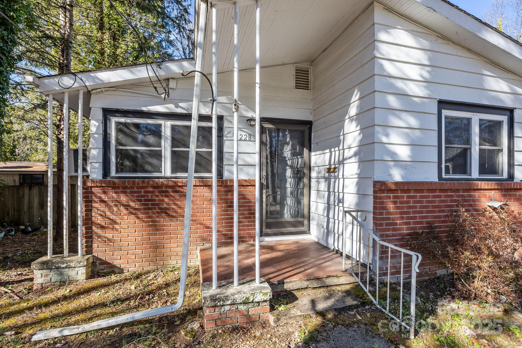 228 Grove Street Brevard, NC 28712 - Photo 3 of 44 front view of a house with a window