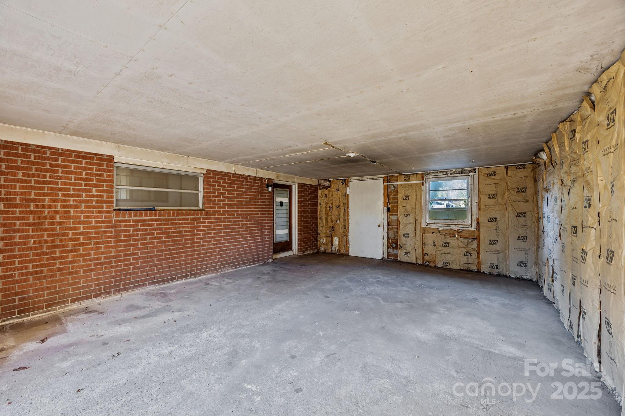 228 Grove Street Brevard, NC 28712 - Photo 32 of 44 a view of an empty room with a fireplace