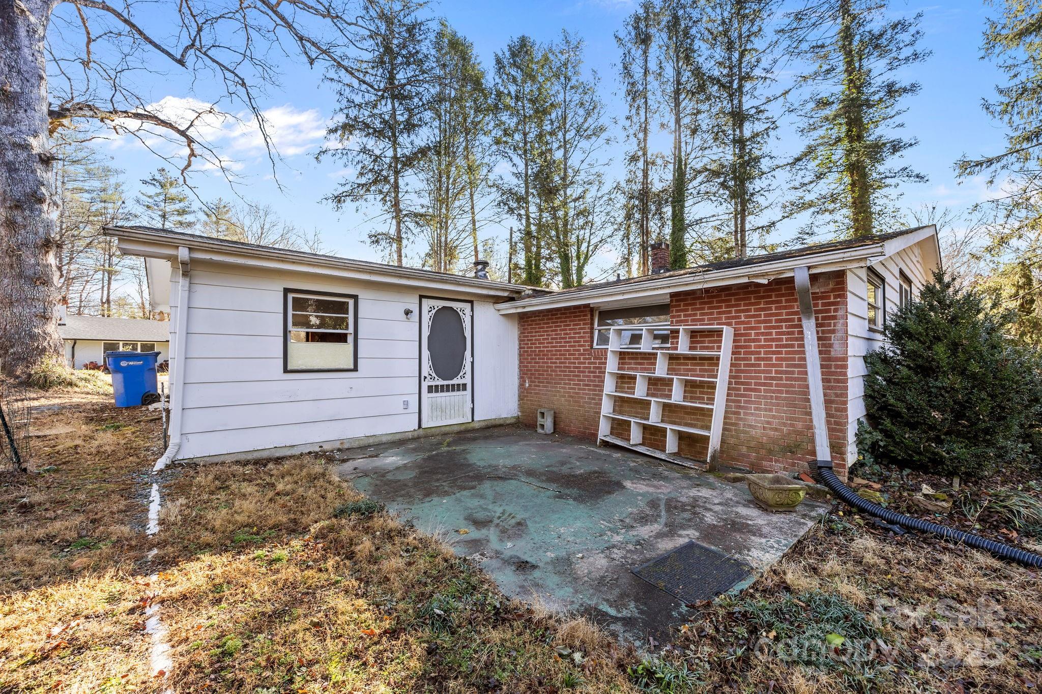228 Grove Street Brevard, NC 28712 - Photo 10 of 44 a view of a house with a yard covered in snow
