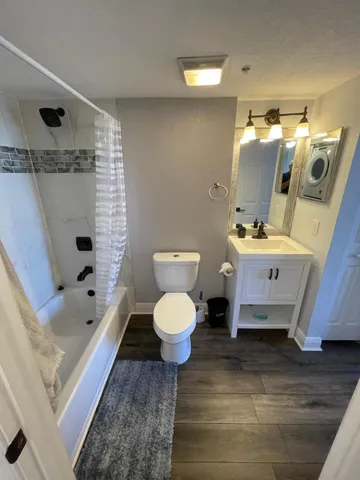 a bathroom with a sink toilet and shower
