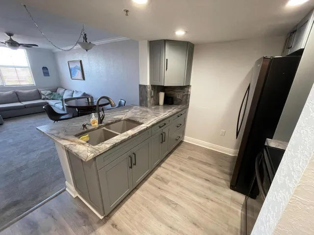a kitchen with a sink stove and refrigerator