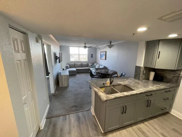 a kitchen with sink cabinets and refrigerator