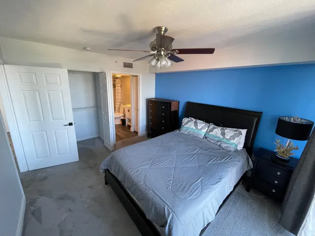 a bedroom with a bed and a television