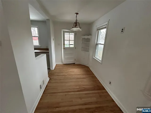 a view of a hallway view with wooden floor and staircase