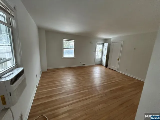 a view of a room with wooden floor and window